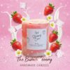 Strawberry, orange, and watermelon shaped scented candles with lit flames, placed on a wooden surface with fresh fruits and warm decorative lights, featuring The Burn Theory logo.